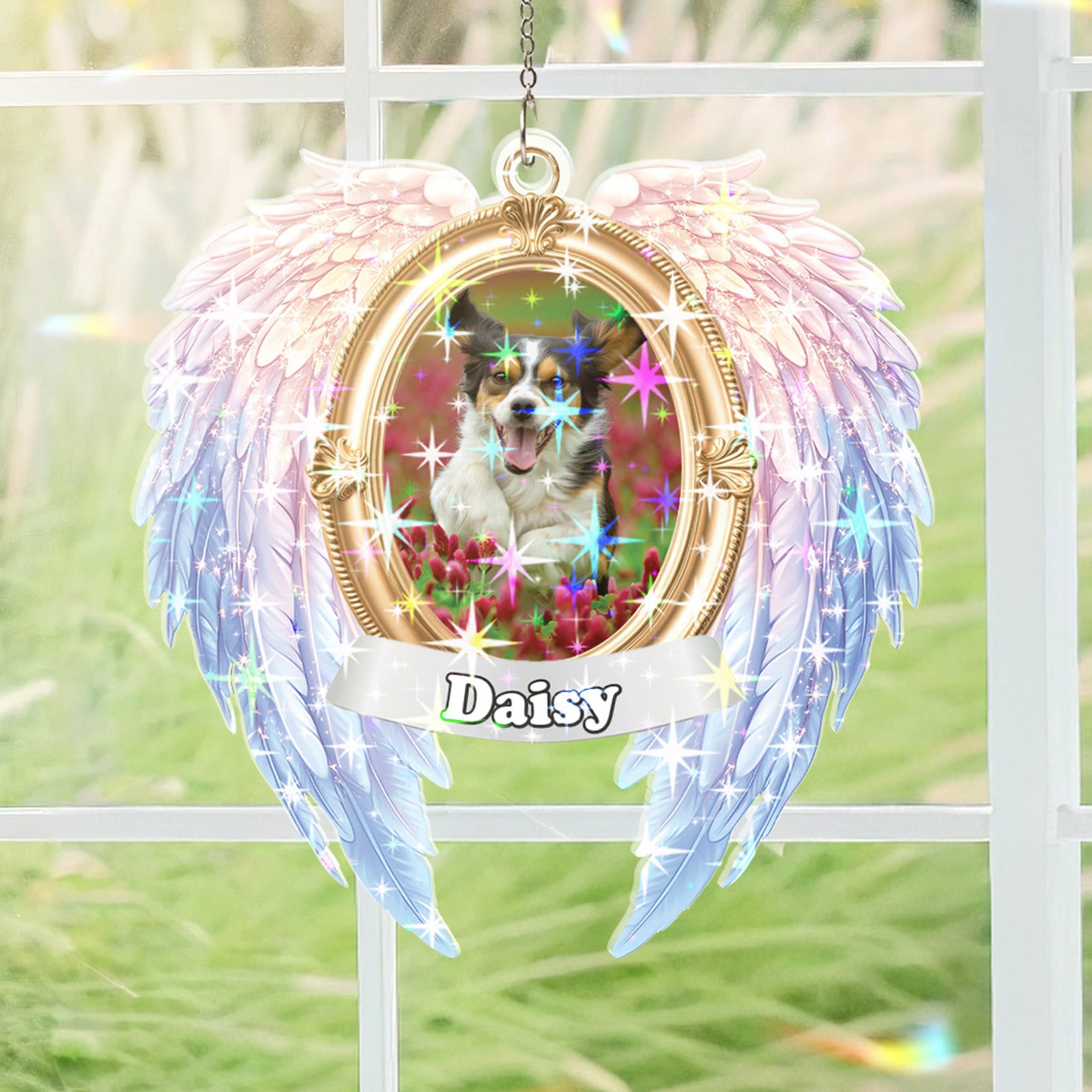 Decorative angel wing ornament with a photo of a dog named Daisy inside a gold frame.